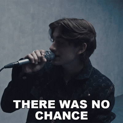 A Man Singing Into A Microphone With The Words There Was No Chance Behind Him GIF