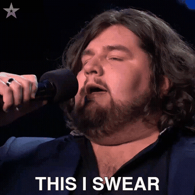 A Man Singing Into A Microphone With The Words " This I Swear " Behind Him GIF