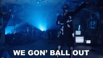 A Man Singing Into A Microphone With The Words " We Gon ' Ball Out " Behind Him GIF