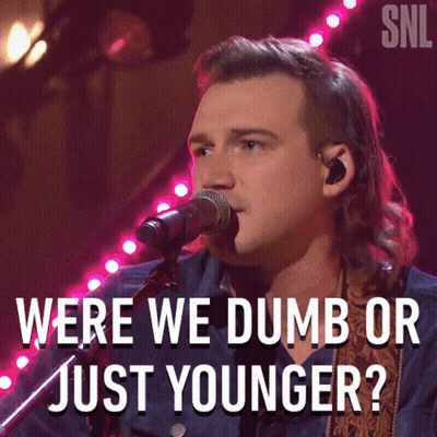 A Man Singing Into A Microphone With The Words Were We Dumb Or Just Younger On The Bottom GIF
