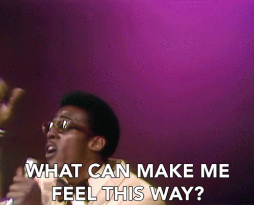 A Man Singing Into A Microphone With The Words " What Can Make Me Feel This Way " On The Bottom GIF