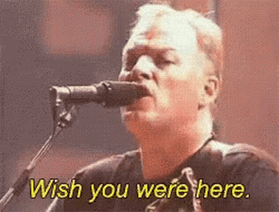 A Man Singing Into A Microphone With The Words Wish You Were Here Above Him GIF