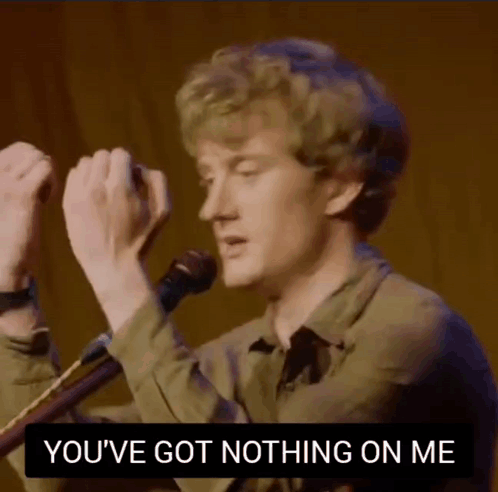 A Man Singing Into A Microphone With The Words " You 'Ve Got Nothing On Me " Above Him GIF