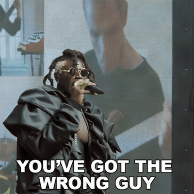 A Man Singing Into A Microphone With The Words " You 'Ve Got The Wrong Guy " Below Him GIF