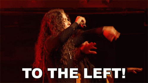 A Man Singing Into A Microphone With To The Left Written Below Him GIF