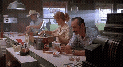 A Man Sits At A Counter In A Diner With A Box Of Upside Down Ketchup GIF