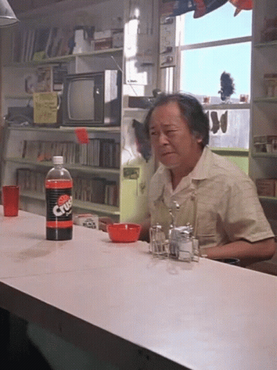 A Man Sits At A Counter With A Bottle Of Diet Dr Pepper On It GIF