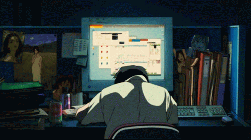 A Man Sits At A Desk In Front Of A Computer Screen That Says ' Microsoft ' GIF
