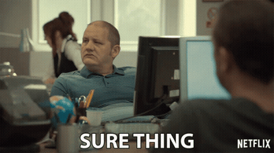 A Man Sits At A Desk In Front Of A Computer With A Netflix Logo In The Corner GIF