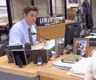 A Man Sits At A Desk In Front Of A Hp Computer Monitor GIF