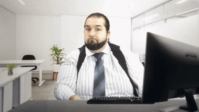 A Man Sits At A Desk With A Benq Monitor GIF