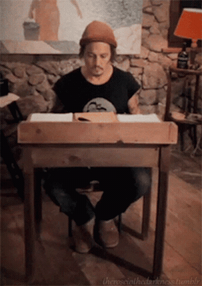 A Man Sits At A Wooden Desk With The Words " The Social Darkness Tumblr " On The Bottom Right GIF