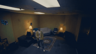 A Man Sits In A Chair In A Living Room With A Couch And Rug GIF