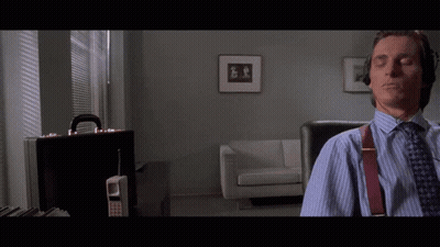 A Man Sits In A Chair With His Eyes Closed In A Living Room GIF