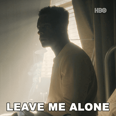 A Man Sits In A Dark Room With The Words " Leave Me Alone " On The Bottom GIF