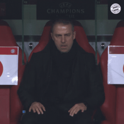 A Man Sits In A Soccer Locker Room With A Sign That Says Champions GIF