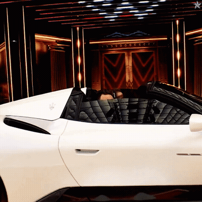 A Man Sits In A White Sports Car With The Word Maserati On The Side GIF