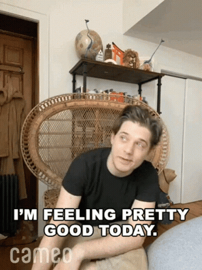 A Man Sits In A Wicker Chair With The Words " I 'M Feeling Pretty Good Today " Above Him GIF