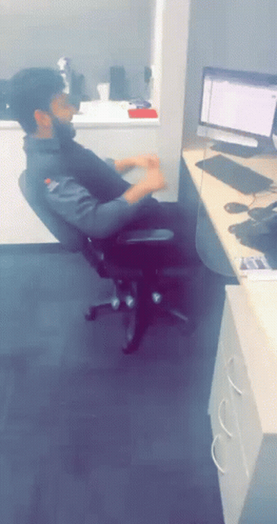 A Man Sits In An Office Chair In Front Of A Computer Screen GIF