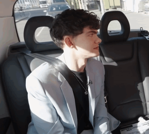 A Man Sits In The Back Seat Of A Car GIF