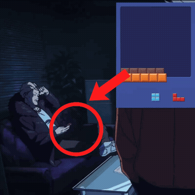 A Man Sits On A Couch Looking At His Phone Next To A Tetris Screen GIF