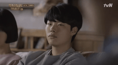 A Man Sits On A Couch With A Tvn Logo In The Corner GIF