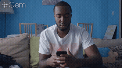 A Man Sits On A Couch With His Eyes Closed And A Gem Logo Behind Him GIF