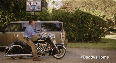 A Man Sits On A Motorcycle In Front Of A Van And A Basketball Hoop With The Hashtag #Daddyshome GIF