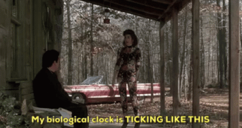 A Man Sits On A Porch Next To A Woman Who Says " My Biological Clock Is Ticking Like This " . GIF