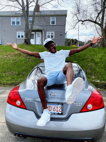 A Man Sits On The Back Of A Nissan Altima GIF