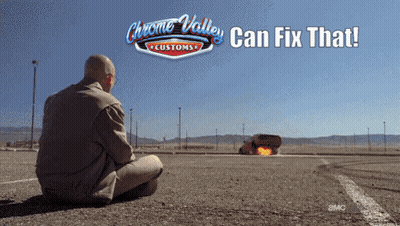A Man Sits On The Ground In Front Of A Chrome Valley Customs Sign GIF