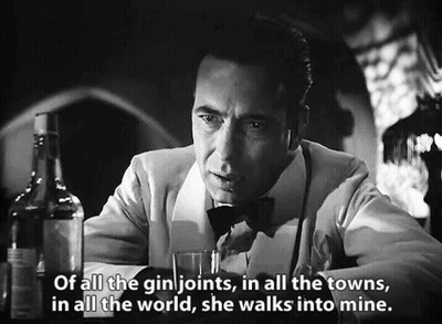 A Man Sitting At A Bar With A Bottle Of Gin And A Glass Of Gin .. GIF