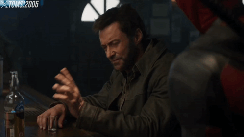 A Man Sitting At A Bar With A Bottle Of Whiskey And The Words I 'M Not Interested GIF
