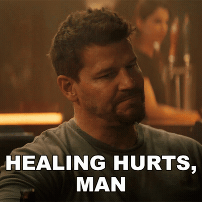 A Man Sitting At A Bar With The Words Healing Hurts Man Behind Him GIF