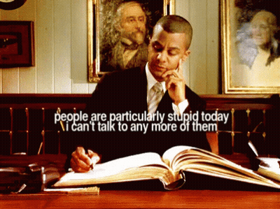 A Man Sitting At A Desk Reading A Book With The Words People Are Particularly Stupid Today GIF