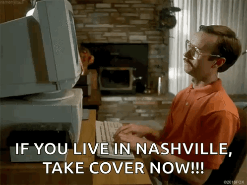 A Man Sitting At A Desk Typing On A Keyboard With The Words If You Live In Nashville Take Cover Now GIF