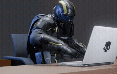 A Man Sitting At A Desk Using A Laptop With A Skull And Crossbones Logo GIF
