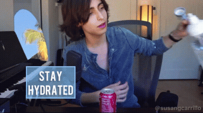 A Man Sitting At A Desk With A Can Of Coca Cola GIF