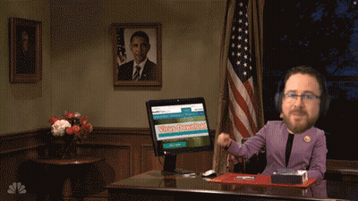 A Man Sitting At A Desk With A Computer Screen That Says Virus Download On It GIF