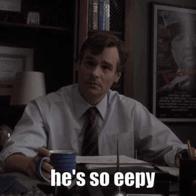 A Man Sitting At A Desk With A Cup Of Coffee And The Words He 'S So Eepy On The Bottom GIF