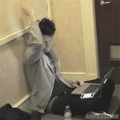 A Man Sitting At A Desk With A Laptop And A Bottle Of Water With The Word Bastillestorm On The Bottom GIF