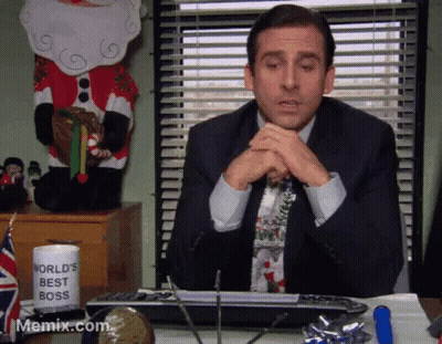 A Man Sitting At A Desk With A World 'S Best Boss Mug On It GIF