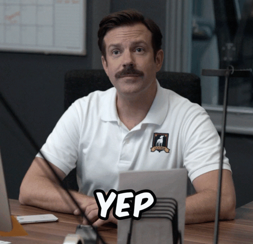 A Man Sitting At A Desk With A Yep Sticker GIF