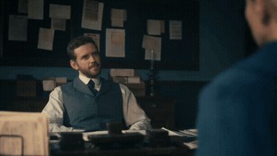 A Man Sitting At A Desk With The Words " And There We Have It " Written Below Him GIF