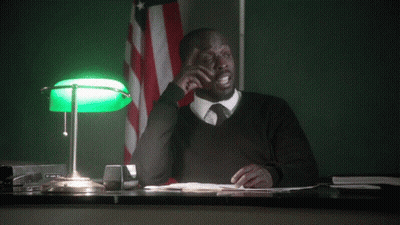 A Man Sitting At A Desk With The Words " Can I Object " Behind Him GIF