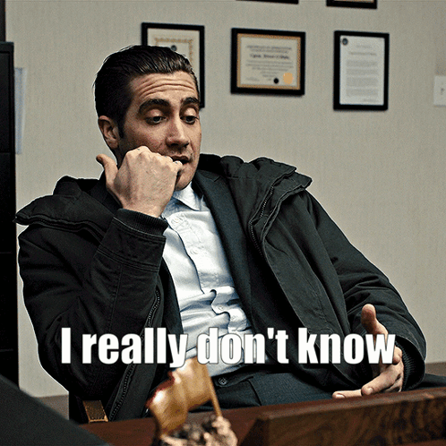 A Man Sitting At A Desk With The Words " I Really Don 'T Know " On The Bottom GIF