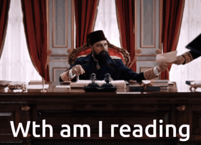 A Man Sitting At A Desk With The Words With Am I Reading GIF