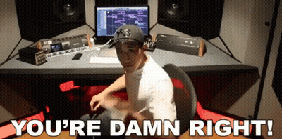 A Man Sitting At A Desk With The Words " You 'Re Damn Right " Written Below Him GIF