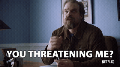 A Man Sitting At A Desk With The Words You Threatening Me GIF