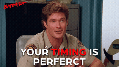 A Man Sitting At A Desk With The Words Your Timing Is Perfect GIF